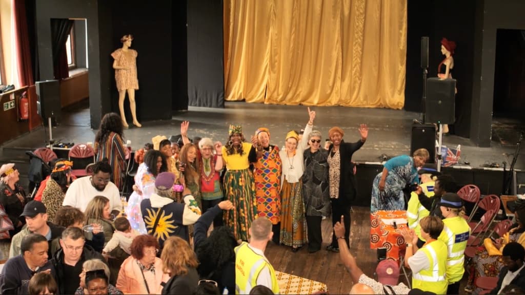 Attendees, volunteers, and performers gathered on stage during Africa Day 2024